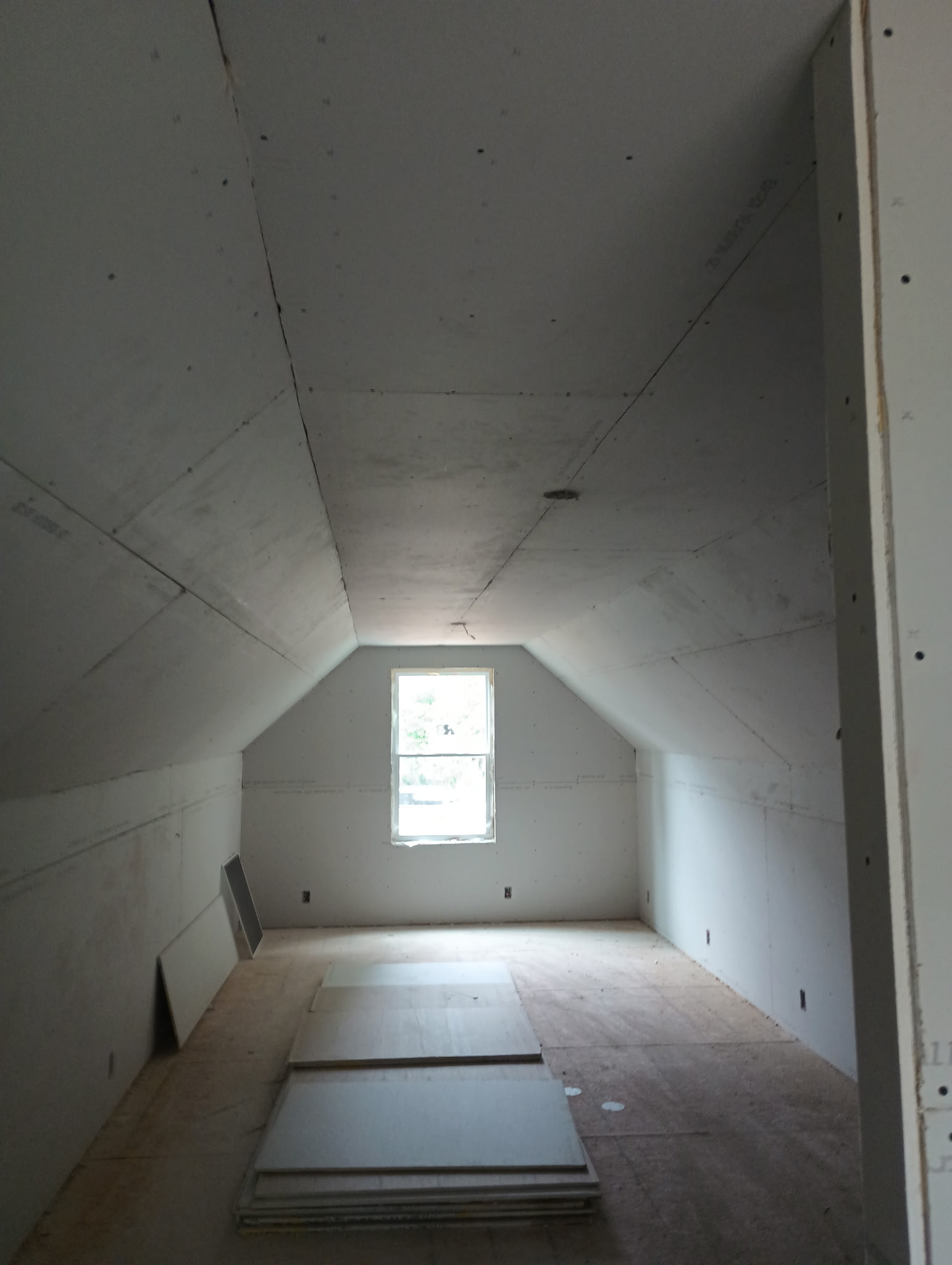 Attic drywall installation before finishing