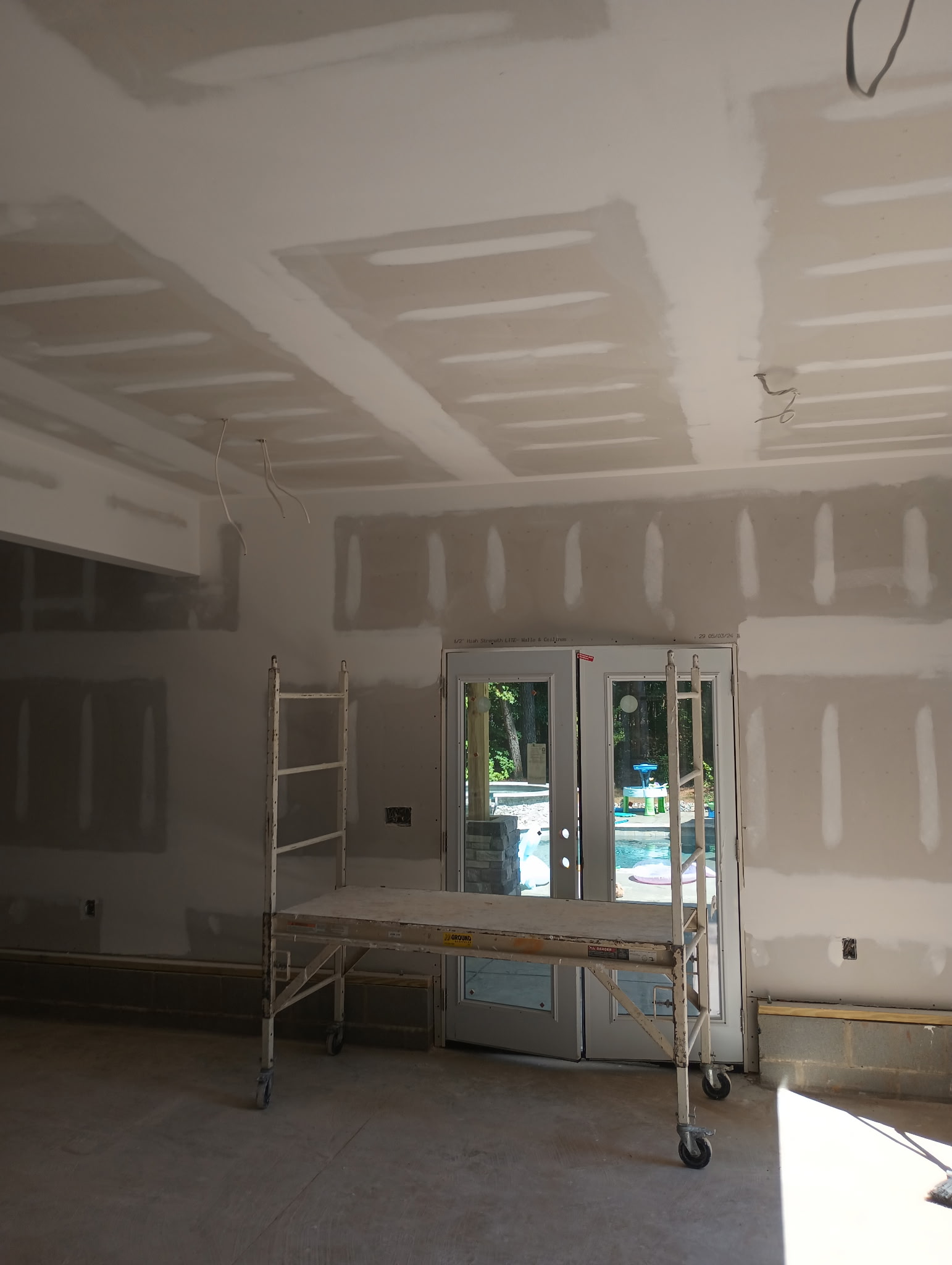 Finished drywall room with scaffold