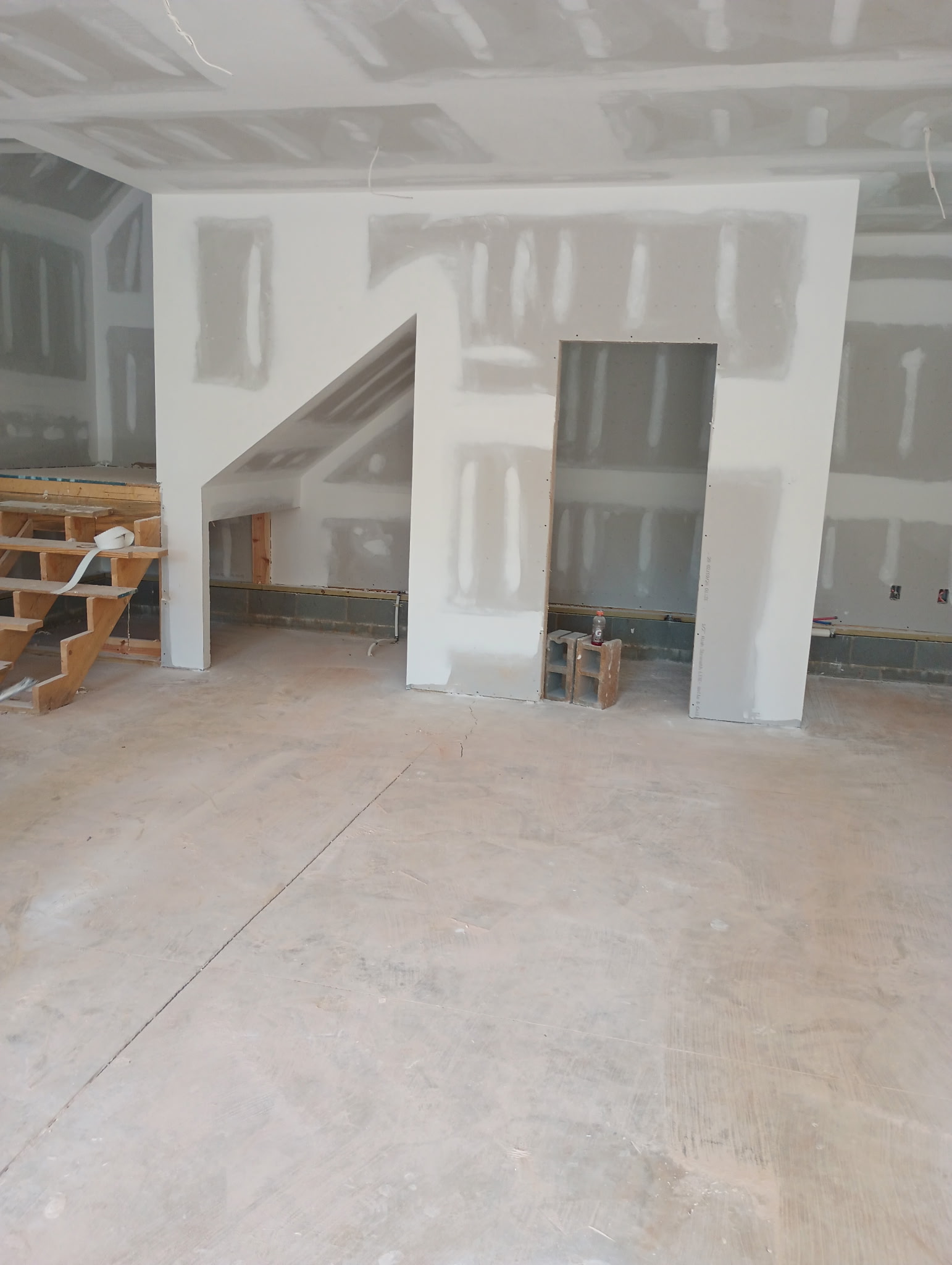 Drywall room with staircase and openings